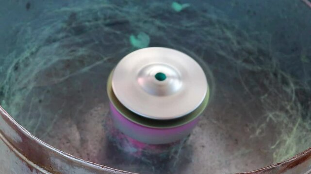 cotton candy being spun and made in manual cotton candy machine