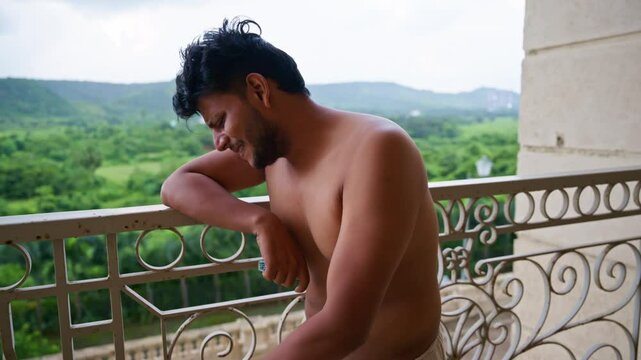 Distressed Man Crying on Balcony with Cigarette