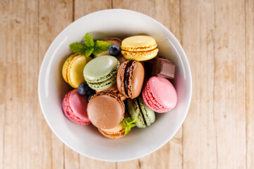 colorful macaroons in bowl, top view
