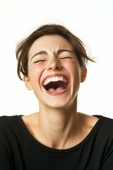 A woman laughing with her eyes closed.