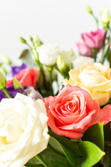 A beautiful bouquet of vibrant roses, eucalyptus, and delicate eustoma in white, pink, and purple hues, perfect for a summer anniversary or birthday celebration
