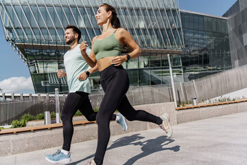 Two Runners Enjoying an Active Morning Workout in a Modern Urban Environment Under Clear Skies