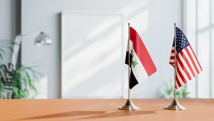FLAGS OF IRAQ AND USA ON TABLE