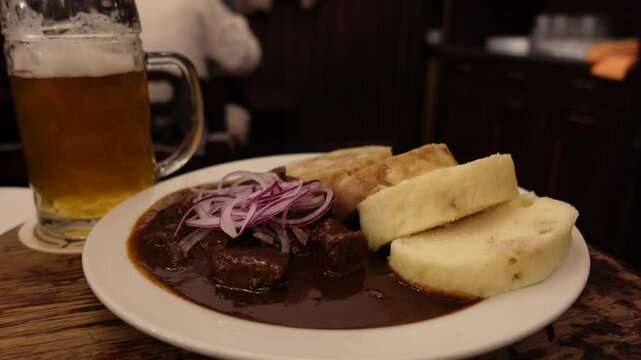 Traditional Czech dumplings with beef gulash, onions, and beer
