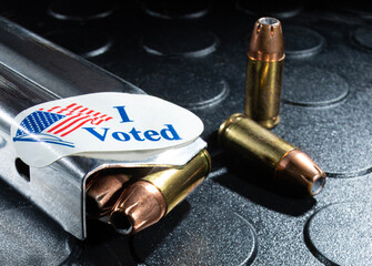 I voted sticker on a loaded pistol magazine