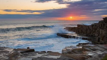 A coastal cliff with waves crashing against the rocks and the sun setting in the background.