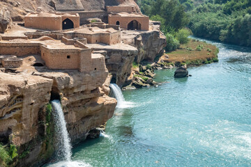 A waterfall is beautifully surrounded by a body of water, Shushtar, Iran