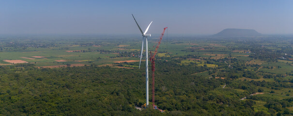 Wind turbine being repaired. Engineers are checking turbine wing on top of a  Hight Crane at  Wind...