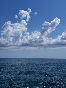 Sea shiny waves, blue sky and amazing clouds.
