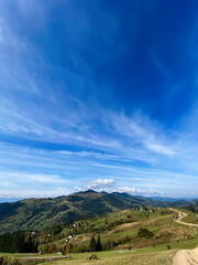 Expansive mountain landscape under a clear blue sky in daytime. Carpathian mountains, Ukraine.