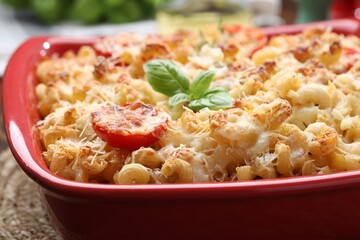 Delicious al forno pasta in baking dish on table, closeup