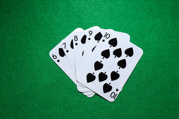 Poker game. Playing cards on green table, flat lay