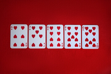 Poker game. Playing cards on red table, top view