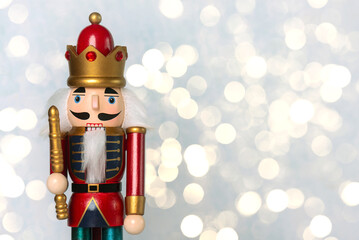 Close up of christmas wooden nutcracker toy soldier with christmas lights and space for text....