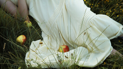 Crop picture of a girl in yellow dress  in the grass.