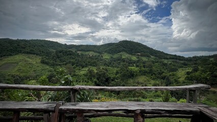 Fototapeta premium Wooden terrace with beautiful mountain view, Bang Kama, Ratchaburi, Thailand.