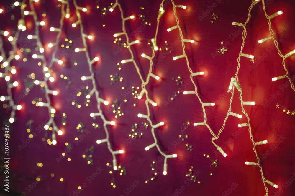 Poster string lights illuminate a deep red background with scattered gold stars.