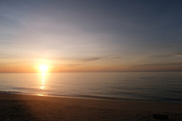 The sun rises at the sea in the morning.