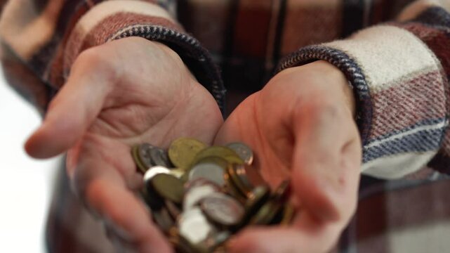 Coins in the man's hands.
Coins in palms.
Penny grains outline in hands.
A man holds a few kopecks.
Money, coins, pennies, metal, business, poverty