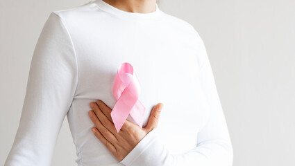 Supporting Breast Cancer awareness concept. Pink ribbon symbol for breast cancer.