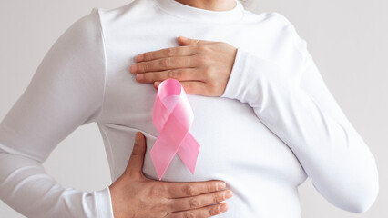 Supporting Breast Cancer awareness concept. Pink ribbon symbol for breast cancer.