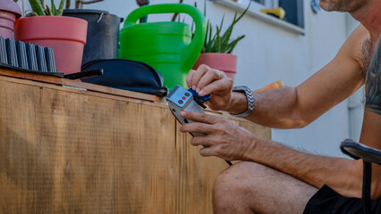 A close-up shot of a man's hand cleaning an electric razor with a brush after shaving in the...