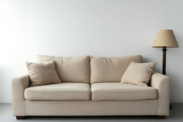 Cozy beige sofa with soft pillows and a stylish lamp in a minimalistic living room setting during daylight hours. Generative AI