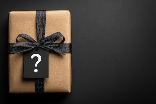 wrapped gift box with question mark tag, symbolizing mystery and surprise. Perfect for celebrations or special occasions
