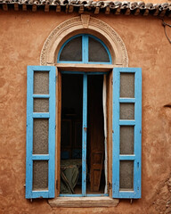 Obraz premium Antique Moroccan wooden door with intricate Islamic geometric patterns, aged turquoise paint, and ornate metal accents, capturing traditional craftsmanship and historic architecture in a rustic old