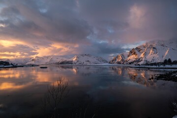 Snowy mountains reflecting in sunset