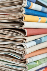 A vibrant stack of assorted magazines showcasing various colorful covers and textures, perfect for publications or interior design inspiration.