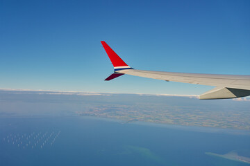 View of airplane wing from an airplane window. Air travel and flight concept