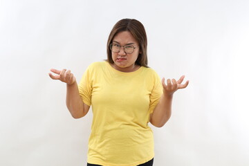 So what. Angry Asian woman raises eyebrows from annoyance keeps palms sideways shrugs shoulders...