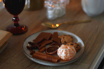 Books, lit candles, red wine, snacks and various deocration on the table. Dark academia or Halloween concept. Selective focus.