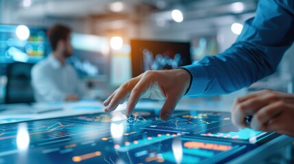 Business professional analyzing data on a digital touchscreen in modern office environment