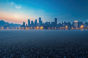 Empty asphalt road and illuminated chongqing skyline at sunset, china