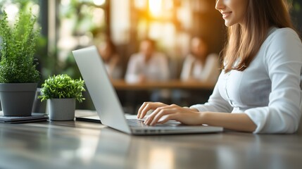 Modern home office scene featuring a focused individual in a comfortable chair,utilizing laptop an web camera for remote hiring success,accompanied by natural lighting ,potted plant decor,and spacious
