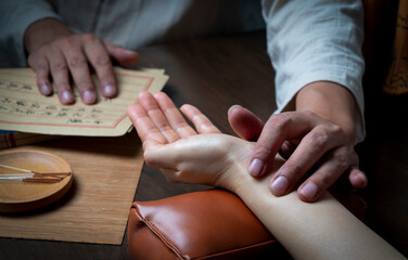 Traditional Chinese Medicine is diagnosing women's pulse