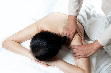 The doctor is massaging the body of a woman