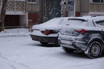 Car under snow in city. Car is covered with snow.