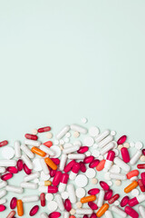 Concept of medicine, healthcare, and pharmaceutical industry. Various colorful pills and capsules...