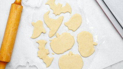 Dough with cookie cutter. Making different shapes of fall cookies for Halloween.