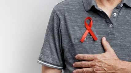 World AIDS Day. Man wears red AIDS awareness ribbon
