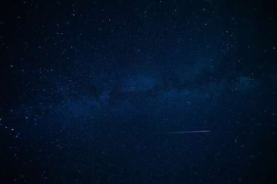 stary night with milky way and shooting star