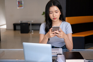 Young woman relaxing with smartphone.