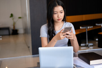 Young woman relaxing with smartphone.