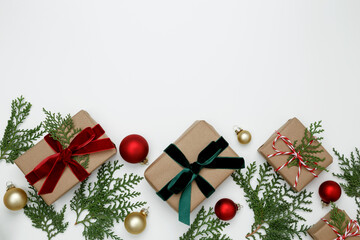 Wrapped Christmas gifts with green thuja branches creating a festive, natural holiday scene