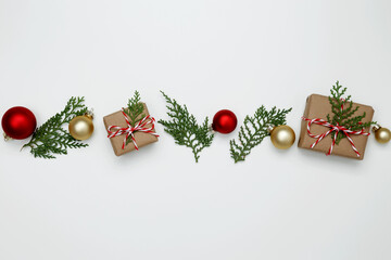 Wrapped Christmas gifts with green thuja branches creating a festive, natural holiday scene