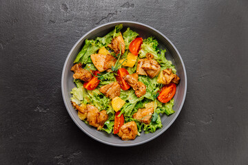 Fresh chicken salad with lettuce, cherry tomatoes, and citrus, perfect for a light and healthy meal