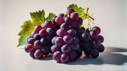 Fresh red grapes on a white surface, a perfect image for healthy eating and food advertising